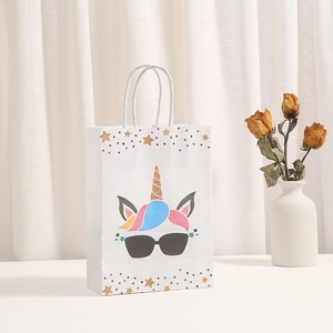 White unicorn paper gift bag with gold foil star patterns and braided handles