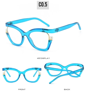 Detail view of blue cat-eye glasses frame with pearl accents and golden metal hinges