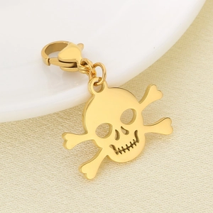 Macro shot of gold skull and crossbones charm with high-polished lobster clasp detail