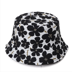 Top-down view of summer cotton bucket hat featuring vintage black floral prints