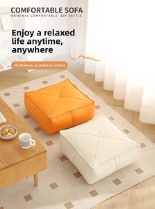 Detail view of thickened square floor cushions in orange and cream faux leather texture