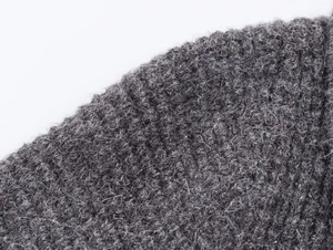 Macro texture of charcoal heather grey wool cardigan showing fluffy knit fiber details
