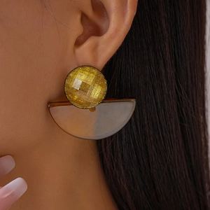 Elegant geometric fan-shaped resin earrings with golden faceted studs on female model