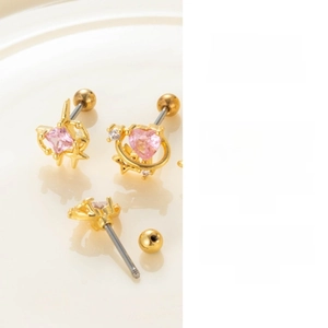 Detail of pink heart and star zircon stud earrings with gold screw back fastening