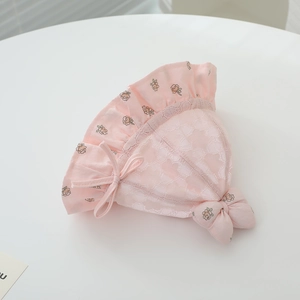 Détail du chapeau de soleil rose pour bébé avec coton floral, dentelle et petit nœud