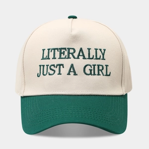 Detail of color-block baseball cap featuring LITERALLY JUST A GIRL green embroidery
