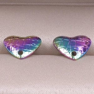 Detailed view of rainbow heart-shaped stainless steel charms with diamond patterns