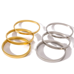 Minimalist 18K gold and silver stainless steel bangles set on a clean white background