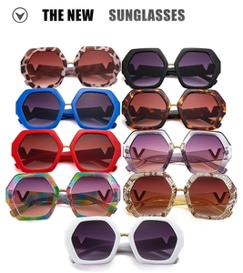 Detailed grid of oversized hexagonal sunglasses in nine colors with V metal logo accents