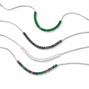 Detailed set of four adjustable stainless steel bracelets with vibrant zircon gemstones