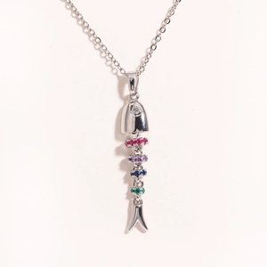 Detail of silver fishbone pendant featuring colorful gemstones and a movable body link