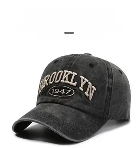 Detailed close-up of 3D Brooklyn 1947 embroidery on washed denim baseball cap texture
