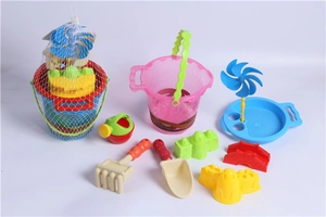 Detail view of colorful kids sand toy set including buckets, shovels and windmill sieve