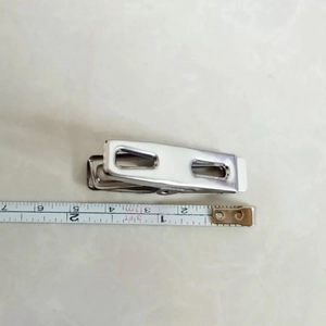 Detailed view of a 6cm stainless steel clothespin with ruler measuring its size