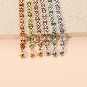 Detail of 18K gold leaf-link stainless steel bracelets with colorful enamel inlay