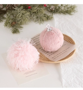 Pink plush Christmas ball ornaments with pearls and silver hangers on white background