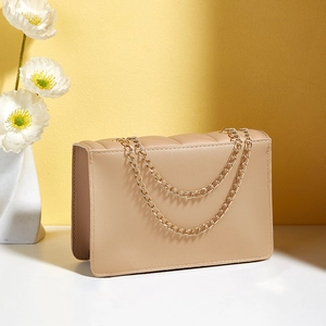 Elegant beige quilted crossbody bag with textured pattern and gold chain strap