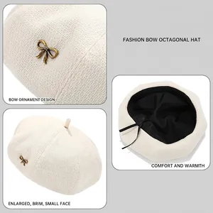 Solid cream wool beret for women with a vintage bronze metal bow detail