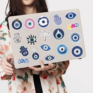 Evil eye stickers on laptop showing Turkish Nazar and Hamsa patterns for decoration