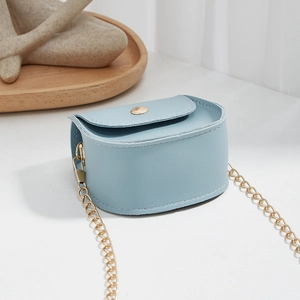 Mini light blue textured leather crossbody bag with elegant gold chain and snap closure