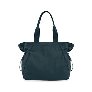 Detail view of water-resistant navy blue nylon tote bag with side adjustable drawstrings