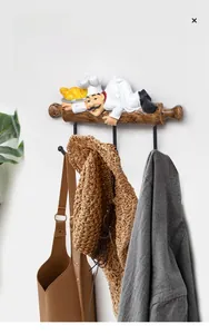 Detail showing the chef figurine wall hook with smooth metal hooks and wood grain texture