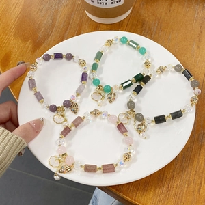 Close-up of bohemian beaded bracelet set with starfish charms and colorful crystals