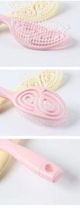 Detail view of pink vented hairbrush showing curved bristles and hollow massage structure