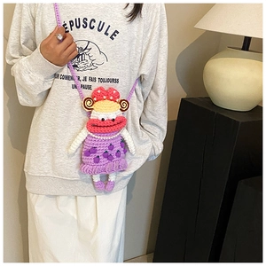 Detail of pink and purple crochet crossbody bag with pearl necklace and doll face