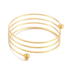 Polished gold multi-layer spiral cuff bracelet with spherical ends on white background