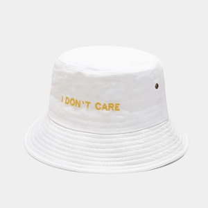 Detail of white cotton bucket hat with yellow I DON'T CARE embroidery and metal eyelet
