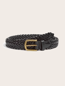 Detail of black woven leather belt with a polished gold buckle on a clean background