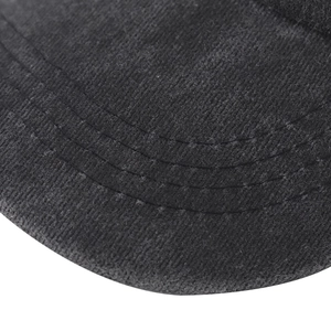 Close-up of the curved visor of a washed cotton baseball cap with triple stitching detail