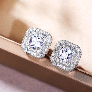 Elegant silver square zircon double halo stud earrings displayed on a jewelry box
