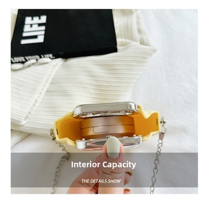 Internal capacity of yellow mini silicone crossbody bag showing space for a powder compact