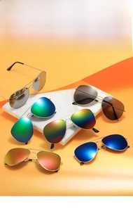 Detail view of colorful aviator sunglasses with gold metal frames and diverse lens tints
