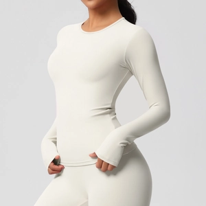 Détail du haut de yoga crème à manches longues avec passe-pouces et tissu extensible doux
