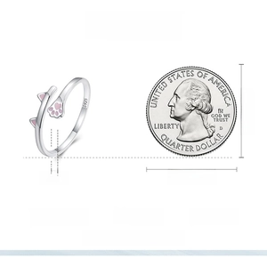 Detailed view of s925 silver cat ring size compared to a quarter dollar coin