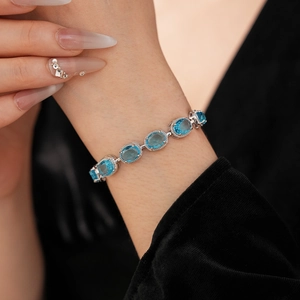 Close-up of light blue oval zircon bracelet with silver base on model's wrist
