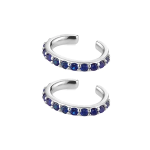 Detailed close-up of silver ear cuffs with vibrant blue round gemstones and an open-loop design