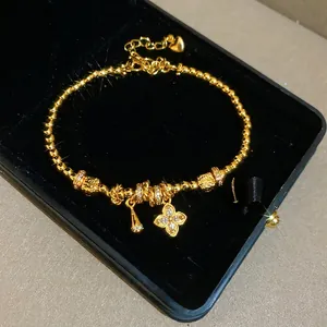 24K gold plated beaded flower bracelet with zircon clover and bell charms in velvet box