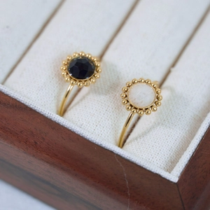 Detailed close-up of retro rings with black and white natural stones in gold settings