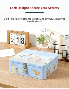 Detail of light blue tin storage box with cartoon fox pattern and silver padlock