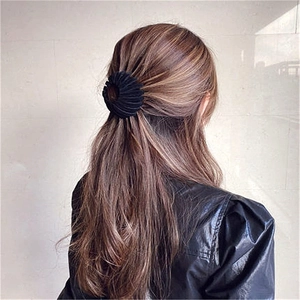 Matte black flocking birds nest hair clip for messy buns and ponytails on brown hair
