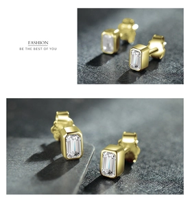 Detail of rectangular zircon stud earrings with gold bezel setting and butterfly backing