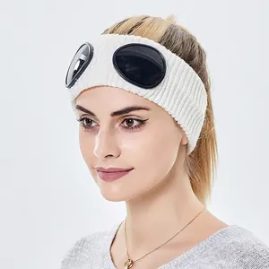 White knitted headband with black goggles for winter outdoor sports and leisure wear