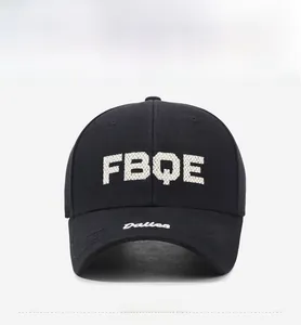 Detailed view of rhinestone FBQE lettering and embroidery on a black baseball cap