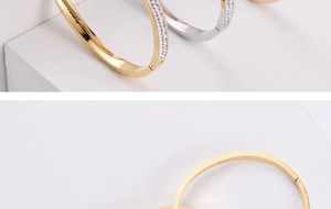 Close-up of gold, silver and rose gold steel bracelets with zircon inlay and clasp detail