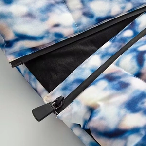 Detailed view of tie-dye printed puffer jacket with high-quality zipper and quilted stitching