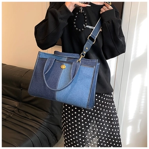 Détail du sac cabas en denim patchwork bleu avec fermoir doré et bandoulière réglable
